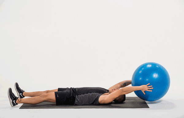 Stability ball hand to feet pass exercise